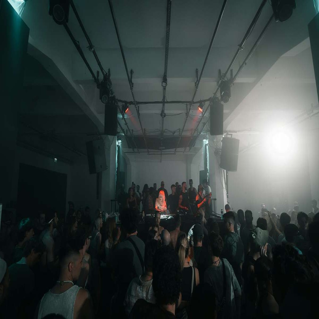 Warehouse rave lighting rig at night